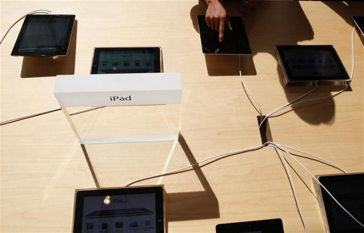 A person tries out an Apple iPad 2 at the company&#039;s new store in Nanjing Road, Shanghai