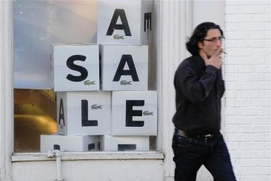 A man walks past a &quot;sale&quot; sign in the Georgetown shopping district in Washington