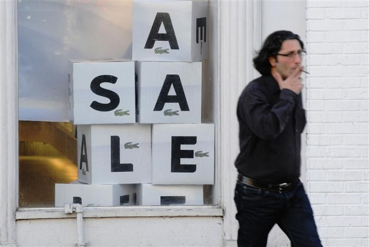 A man walks past a &quot;sale&quot; sign in the Georgetown shopping district in Washington