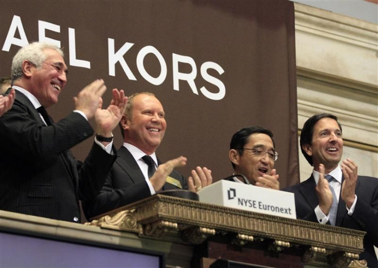 Designer Michael Kors celebrates after ringing the opening bell with guests of Michael Kors Holdings Ltd. at the New York Stock Exchange