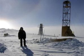 A man stands near drilling apparatus at the Vostock research camp in Antarctica in this January 13, 2006 handout photograph.