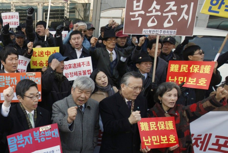 Protesters attend rally held by former North Korean defectors and anti-North Korean activists near the Chinese Embassy in Seoul