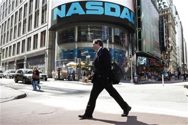 A pedestrian walks past the NASDAQ building in New York City