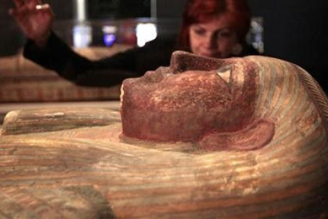 World cultures keeper Henrietta Lidchi poses for a photograph looking at a coffin of Ankhhor during a media viewing of the &#039;Fascinating Mummies&#039; exhibition at the National Museum of Scotland in Edinburgh, Scotland February 10, 2012.
