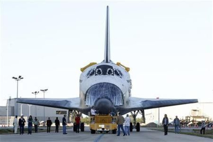 The space shuttle Atlantis is moved towards the huge Vertical Assembly Building for work in its decommissioning at the Kennedy Space Center (KSC) in Cape Canaveral, Florida, January 20, 2012.