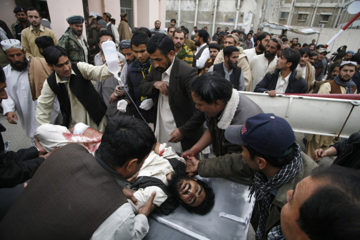 People wheel a man who was injured by a bomb explosion, at a hospital in Quetta