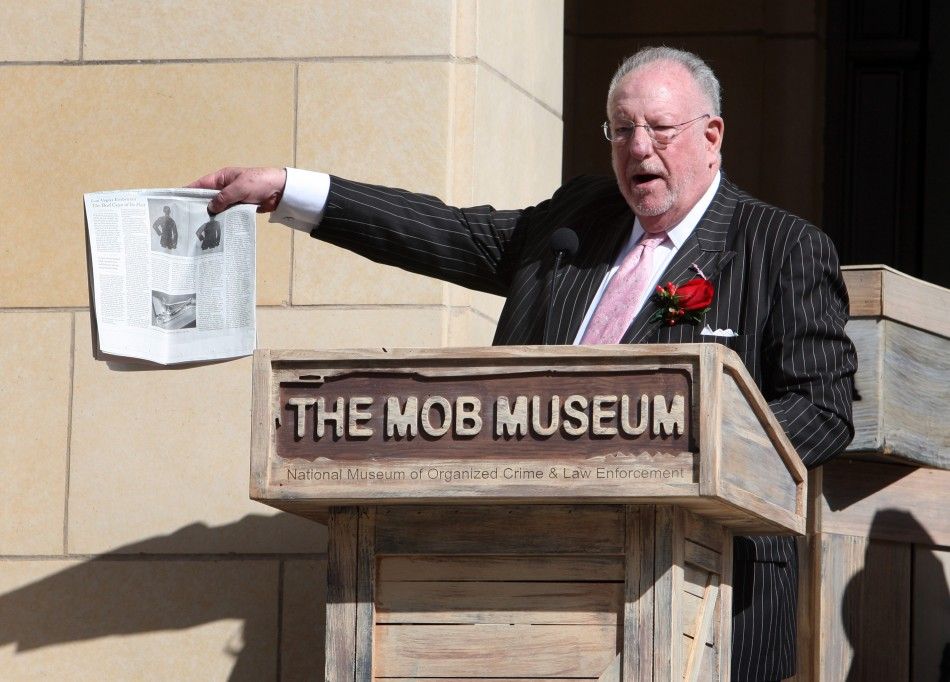 Former Las Vegas Mayor Oscar Goodman holds up a news article with a story on The Mob Museum during the museum039s grand opening in Las Vegas