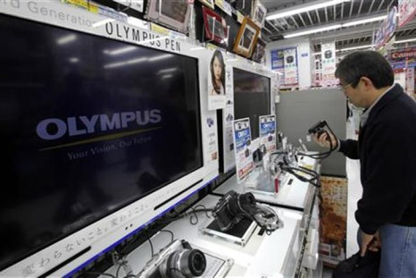Man looks at Olympus Corp digital cameras at an electronics store in Tokyo