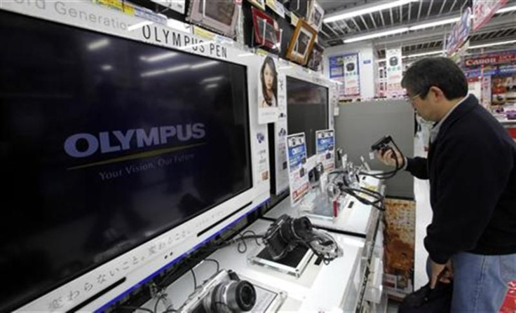 Man looks at Olympus Corp digital cameras at an electronics store in Tokyo