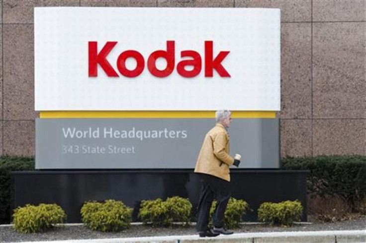 A man walks past the Kodak World Headquarters sign in Rochester, New York