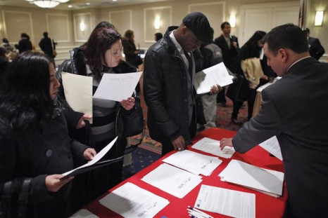 People talk with a job recruiter while they attend the &quot;JobEXPO&quot; job fair in New York