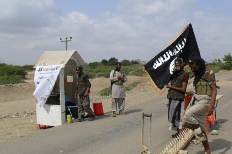 Al Qaeda militants man a checkpoint at the entrance of the southern Yemeni city of Zinjibar