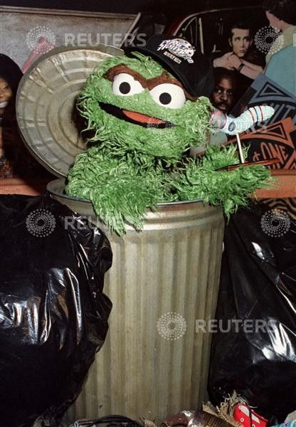 Characters from the children's television programme "Sesame Street", Oscar the Grouch" (L) and Slime..