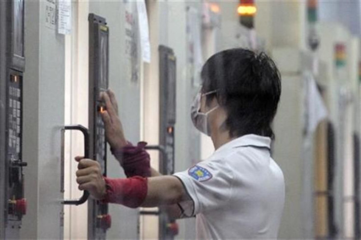 Worker at work during a night shift in Foxconn&#039;s new factory in Zhengzhou, Henan province in central China