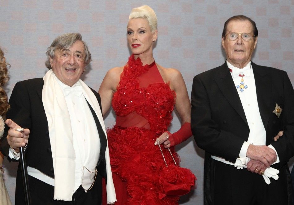 Austrian businessman Richard Lugner poses with Danish actress Brigitte Nielsen and British actor Roger Moore L-R ahead of the traditional Opera Ball in Vienna, February 16, 2012.