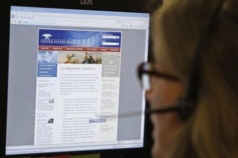 A journalist checks the U.S. Senate's website after it was attacked in 2011.