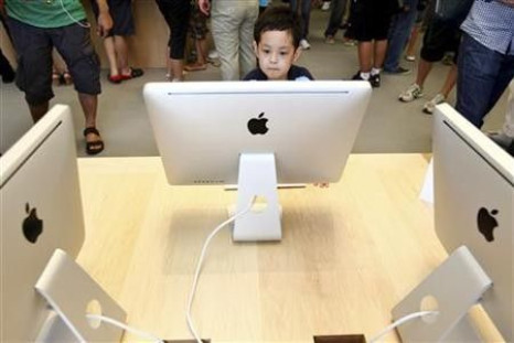 A boy looks at an Apple iMac desktop computer at the new Apple Store in Pudong Lujiazui, in Shanghai July 10, 2010.