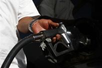 A motorist pumps fuel into his vehicle 