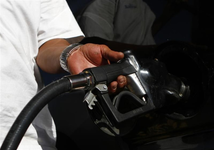 A motorist pumps fuel into his vehicle 