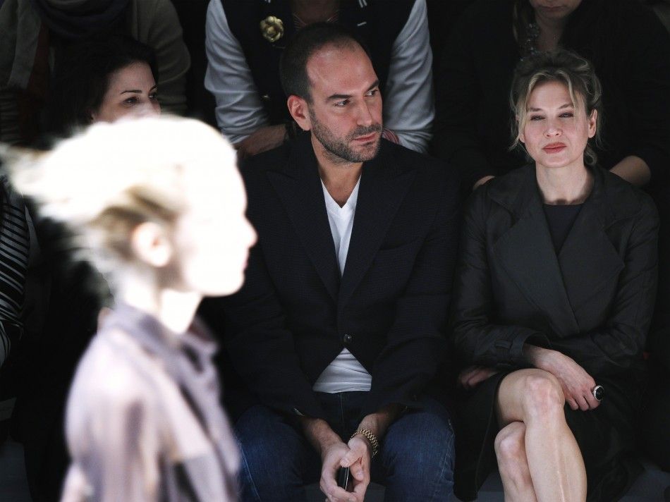 Actress Renee Zellweger R watches a model during a presentation of the Vera Wang FallWinter 2012 collection during New York Fashion Week February 14, 2012.