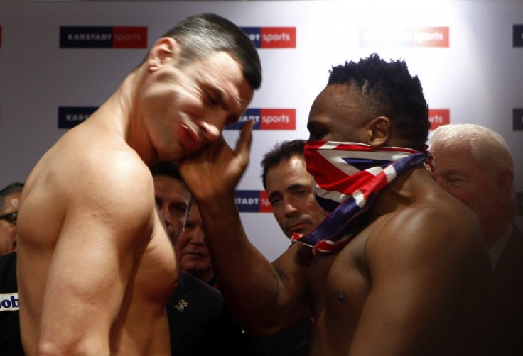 Dereck Chisora slaps Vitali Klitschko at their weigh-in in Munich.