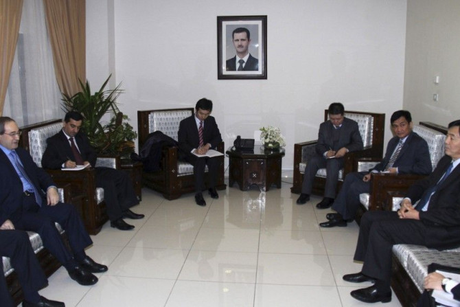 Syrian Deputy Foreign Minister Faisal Mekdad (first L) meets Chinese Vice Foreign Minister Zhai Jun (first R) and other senior diplomats, in Damascus February 17, 2012.
