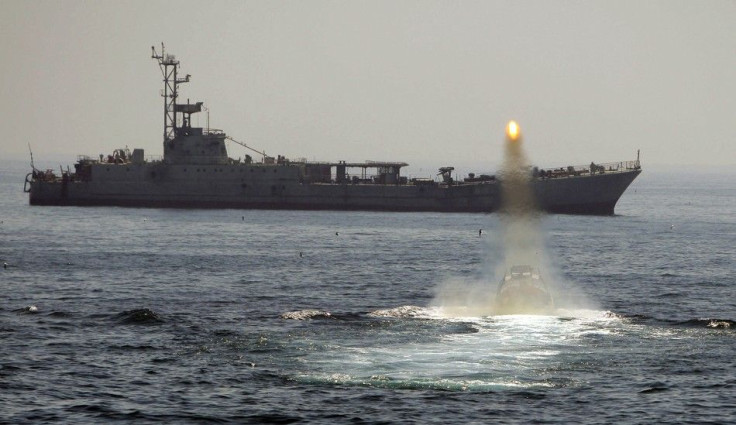 An Iranian warship and speed boats take part in a naval war game in the Persian Gulf and the Strait of Hormuz, southern Iran