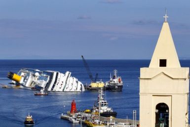 Oil tanker Elba, right, and oil recovery sea platform Meloria, center, are seen on Feb. 15 during the extraction of fuel from the shipwrecked luxury liner Costa Concordia