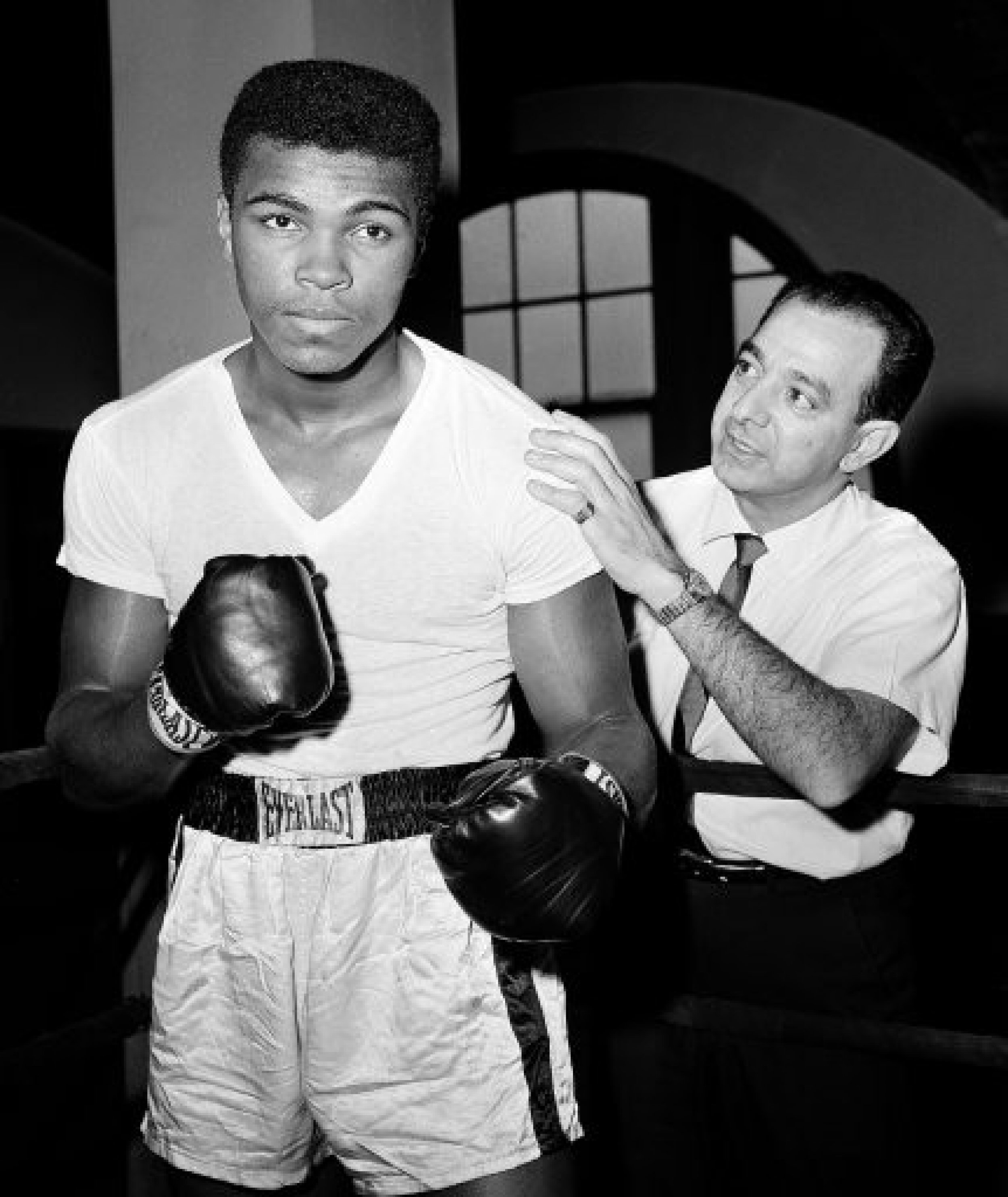 A young Muhammad Ali, left, stands with his trainer Angelo Dundee at City Parks Gym in New York.