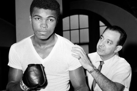A young Muhammad Ali, left, stands with his trainer Angelo Dundee at City Parks Gym in New York.