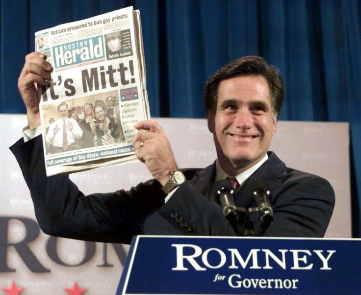 Republican Mitt Romney holds up a Boston newspaper announcing his victory in the Massachusetts Governor's race during his acceptance speech, November 5, 2002 in Boston.