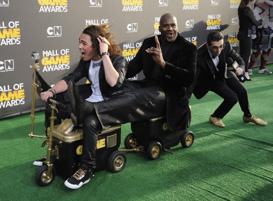 Host Shaquille ONeal C takes a ride with Jackson Rogow L as he arrives at the Cartoon Networks Hall of Game Awards