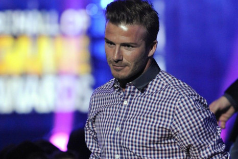 David Beckham holds his son Cruz's hand as he accepts the That's How I Roll award