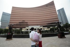 Tourists stand outside the Wynn Casino in Macau