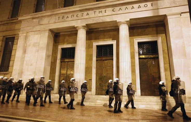 Riot policemen protect building of Bank of Greece during an anti-austerity protest in central Athens