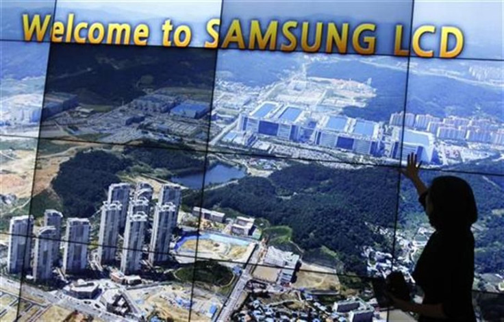An employee of Samsung Electronics explains as a monitor shows the company&#039;s main factory at its showroom in Asan