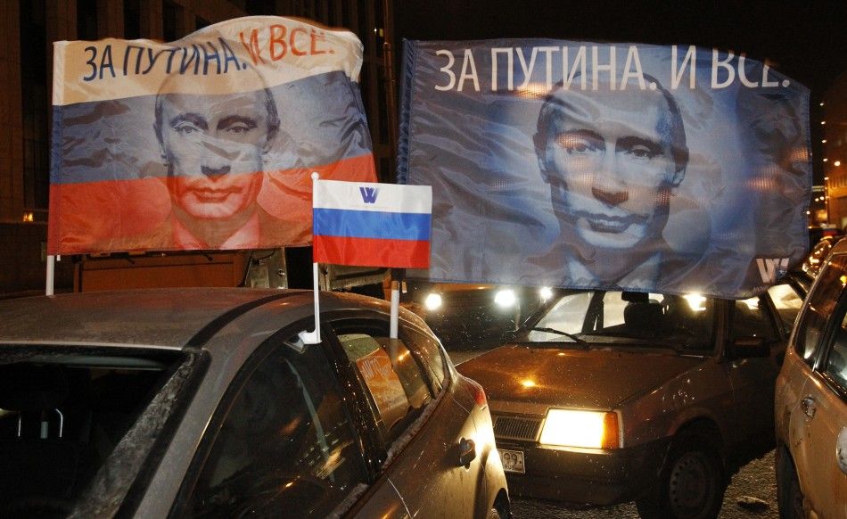 Flags with portraits of Russian Prime Minister Vladimir Putin are displayed during a car rally to show support for Putins presidential candidacy in Moscow Feb. 18, 2012. Russia will go to the polls for a presidential election on March 4. 