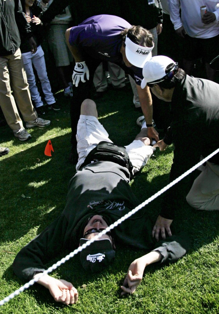 Phil Mickelson retrieves his ball from a fan&#039;s shorts during the Norther Trust Open