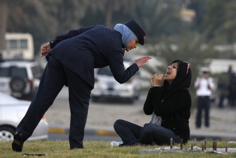 Police officer disciplines Zaynab al-Khawaja in December 2011.