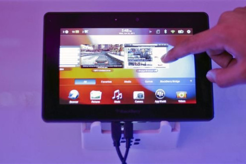 A conference attendee examines the BlackBerry PlayBook during its launch in Mumbai