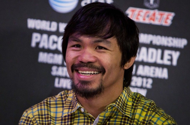 Manny Pacquiao smiles during a news conference to announce his upcoming WBO welterweight championship fight against Timothy Bradley in Los Angeles