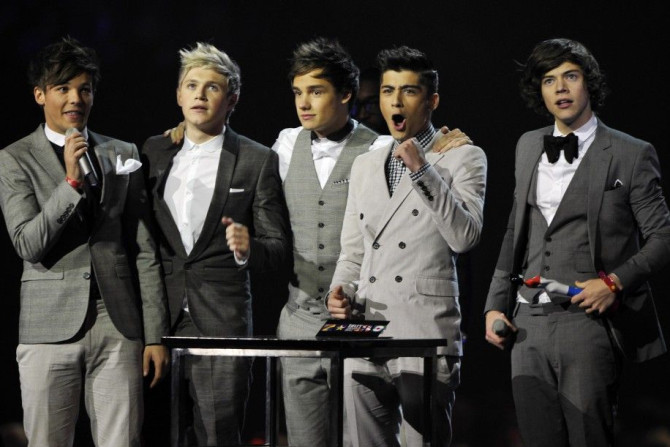 Members of One Direction celebrate after being awarded best British single at 2012 Brit Music Awards for song What Makes You Beautiful