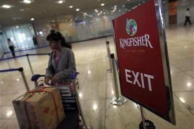 A lone Kingfisher Airlines customer waits in a check-in queue at Mumbai&#039;s domestic airport