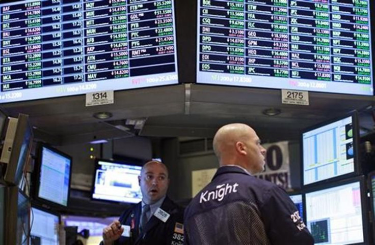 Traders work at the Knight Capital kiosk on the floor of the New York Stock Exchange