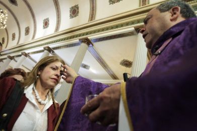 A woman receives ashes during the traditional Ash Wednesday service, at the Metropolitan Cathedral in San Jose.