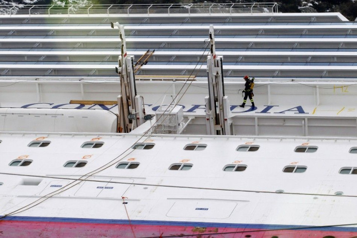 A rescue firefighter walks on the capsized cruise liner Costa Concordia at Giglio island