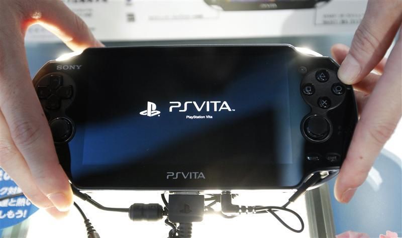 A promotional woman shows a Sony039s PlayStation Vita handheld gaming device at Tokyo Game Show in Chiba