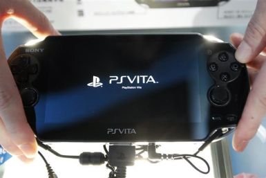 A promotional woman shows a Sony&#039;s PlayStation Vita handheld gaming device at Tokyo Game Show in Chiba