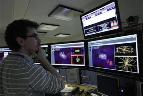 A scientist looks at the first collisions pictures at full power at the Compact Muon Solenoid (CMS) experience control room at the Large European Organisation for Nuclear Research (CERN) in Meyrin, near Geneva March 30, 2010.