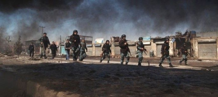 Afghan policemen march towards protesters near a US military base in Kabul. (Reuters: Ahmad Masood)